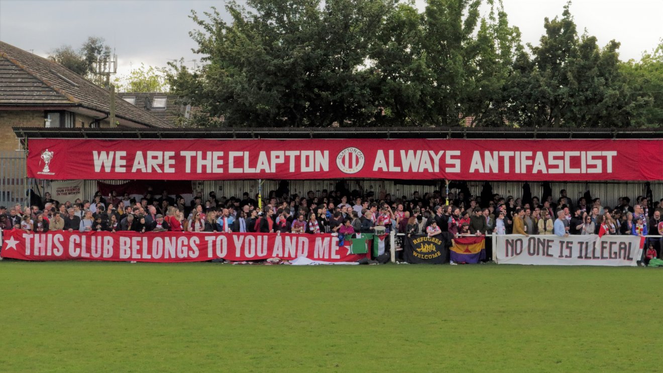 Stadium full of Clapton FC fans with anti-fascist banner